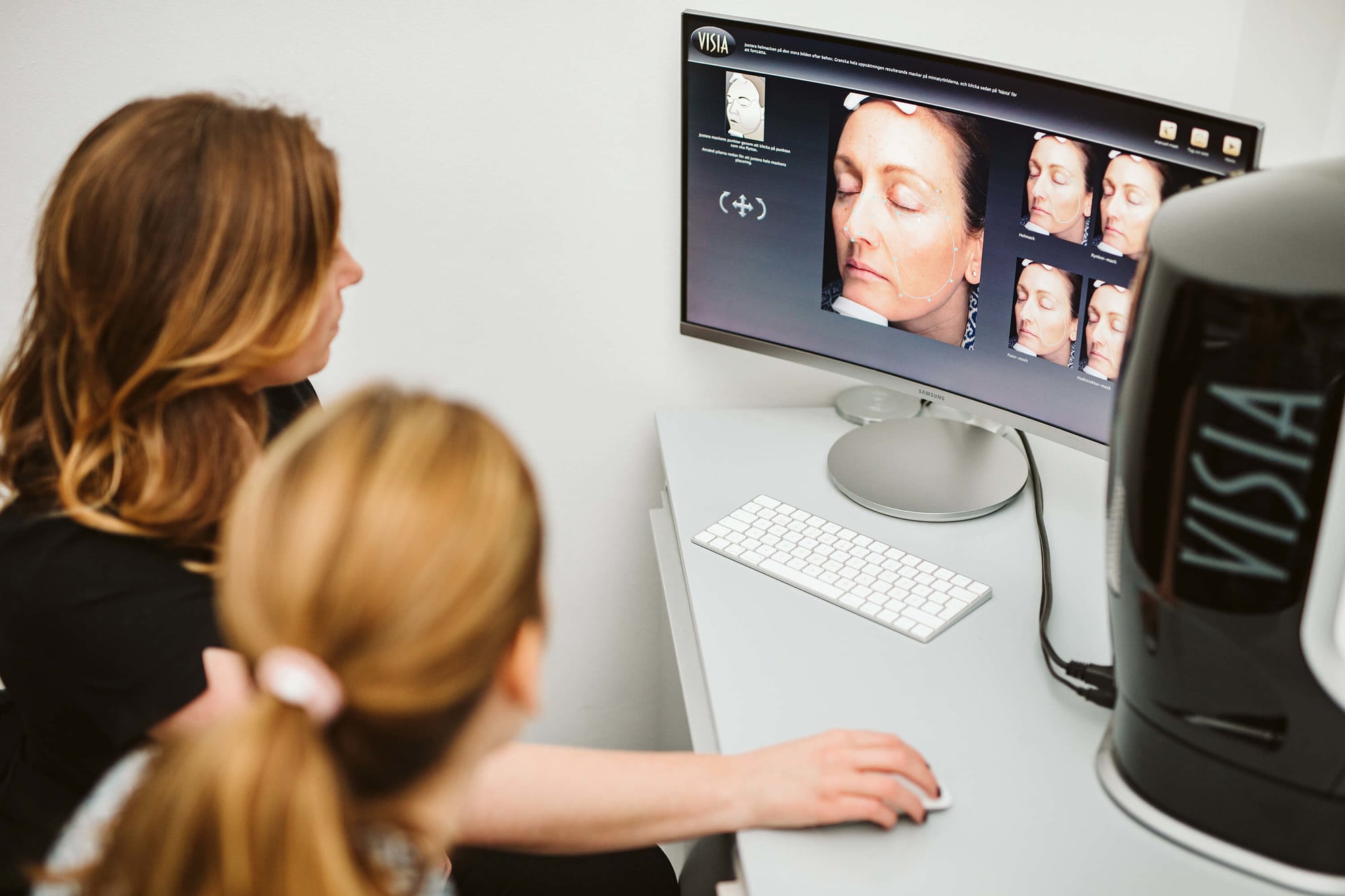 Skin expert conducting a VISIA skin scan analysis on a patient